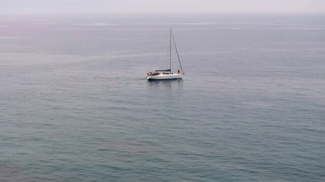 Aerial view of beautiful yacht. Boat on the sea at sunset in summer.