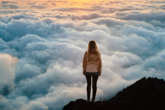 Woman travel solo in Georgia standing above clouds on mountain cliff edge hiking trip outdoor adventure summer vacations tour, girl enjoying harmony with nature freedom epic moments