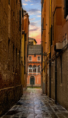 Obraz premium Old narrow streets or calles of Venice, Italy. at sunset