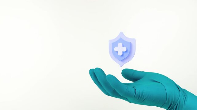 A doctor's hand, wearing green gloves, displays the health shield. Comprehensive medical protection, backed by health insurance and a life insurance policy. Isolated on a white background.