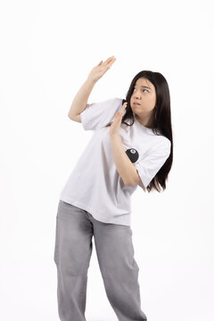 Young woman showing expression of confusion with her hands up
