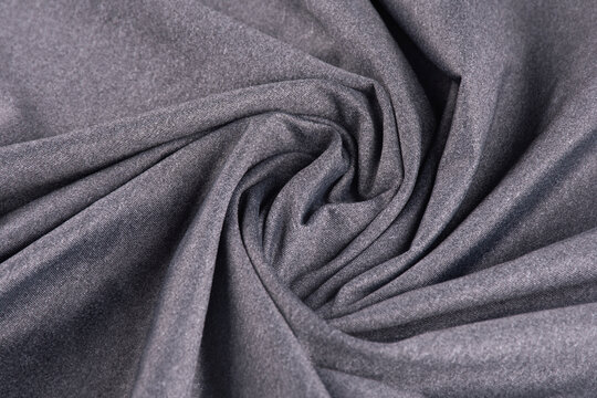 Heather gray dry-fit knit fabric, folded and twisted, polyamide texture, top view.