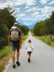 Family dad and child on hiking vacations in Norway parent and kid explore trails outdoors walking together to the mountains, father and daughter on adventure summer activity backpacking trip © EVERST