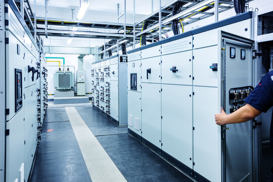 Industrial electrical control room with large switchgear and transformer