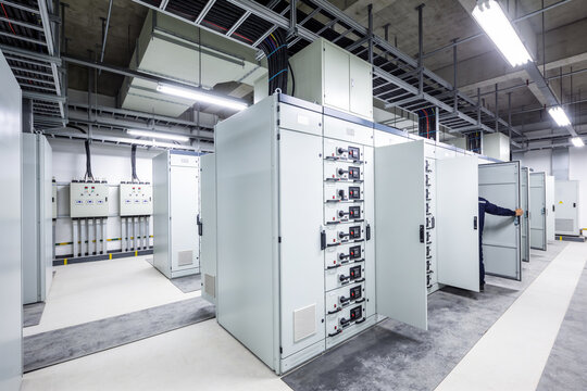 Modern electrical control room with large distribution panels and wiring systems