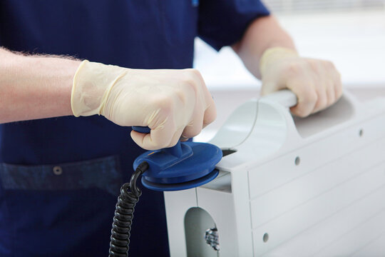 Discharge electrodes in hands of an intensive care doctor. Defibrillator is in hands of resuscitator. Intensive care. Electropulse therapy of cardiac arrhythmias. Saving patient's life