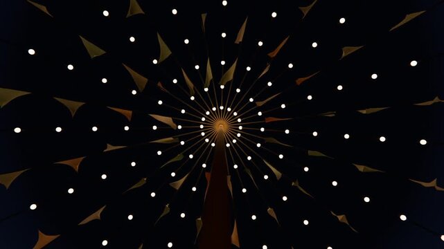 Rotating canopy shifting fabric flags at night as camera recording motion, with lit hub and spokes