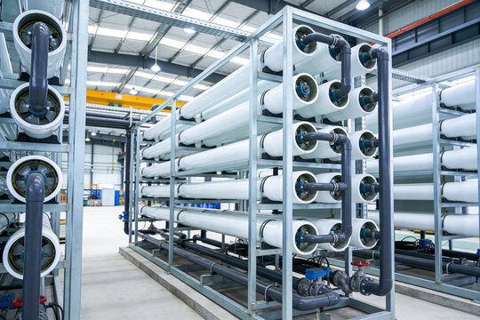 Industrial water filtration system with large white membrane housings and pipes