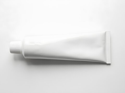 Blank white cosmetic tube for skincare packaging mockup on a clean studio background