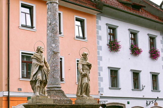 Saints Roch and Anthony, foot of the AD 1751 Plague Column, some XVI c.buildings on Mestni trg square E side in background. Skofja Loka-Slovenia-151