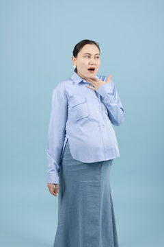 Pregnant woman yawning and looking tired and sleepy in photo studio