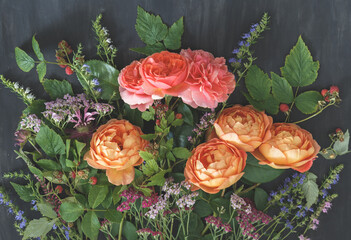 Garden bouquet with coral and orange English roses, yarrow, wildflowers and raspberry branches on dark background © kulikovan