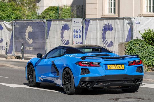 Luxembourg City, Luxembourg - June 22nd 2026 : View on a blue Chevrolet Corvette C8 Stingray Convertible driving on a street.