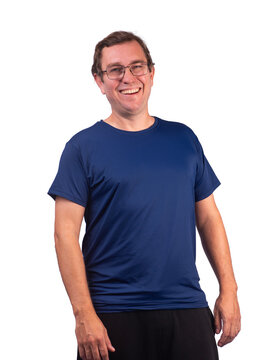 White male model wearing a short-sleeved, shiny navy blue polyamide sports shirt, laughing heartily.
