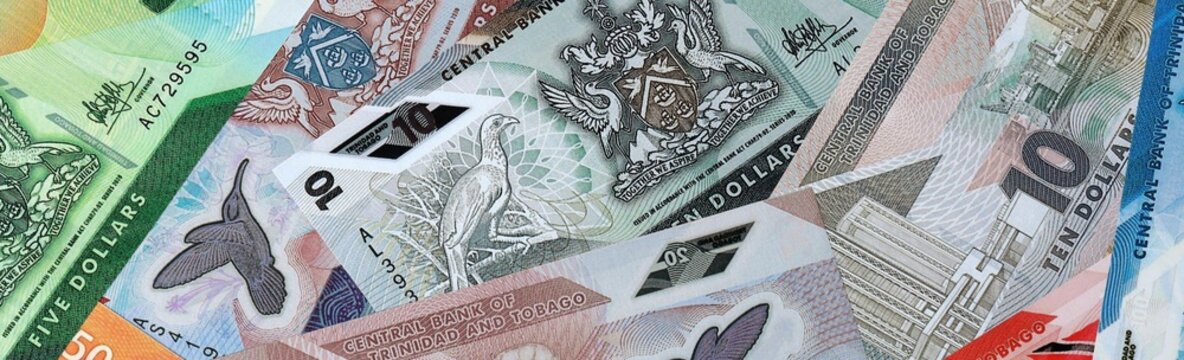 Trinidad and Tobago dollar money bills in pile on table. Trinidad and Tobago TTD currency cash