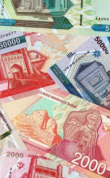 Uzbekistani som money bills in pile on table. Uzbekistan UZS currency cash close up