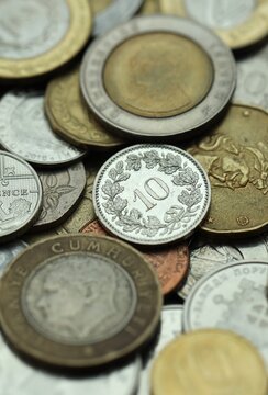 Big pile of coins from various different money currencies. Treasure and numismatics concept