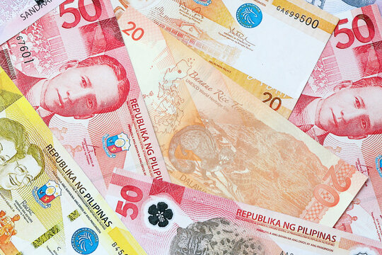 Philippine peso money bills in pile on table. Philippines PHP currency cash close up