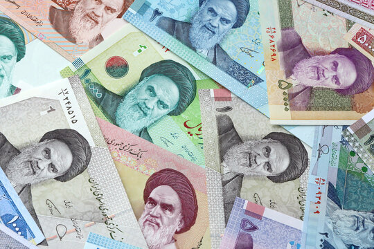 Iranian rial money bills in pile on table. Iran IRR currency cash close up. Concept of gambling
