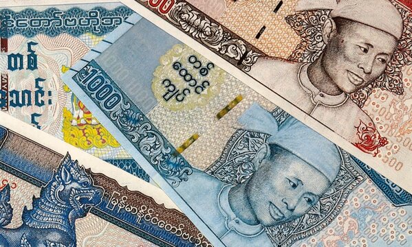 Myanmar kyat money bills in pile on table. Myanmar MMK currency cash close up