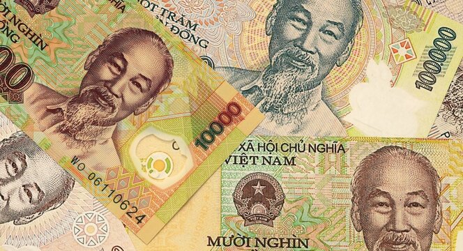 Vietnamese dong money bills in pile on table. Vietnam VND currency cash close up