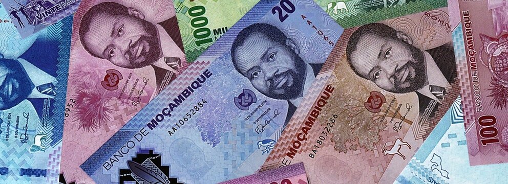 Mozambican metical money bills in pile. Big amount of Mozambique MZN currency cash close up