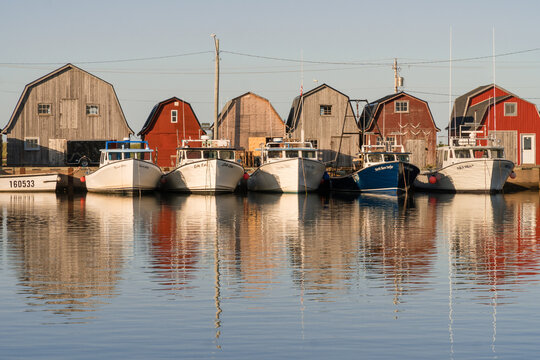 Malpeque Bay, PEI-Canada-August 5, 2019: Fishing boats lined up in quaint fishing harbor.
