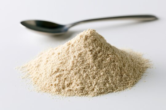 Macro shot of pale guar gum powder on white backdrop for packaging design