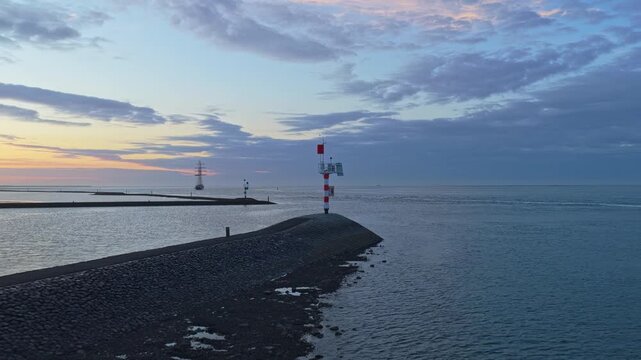 Aerial view of terschelling harbor entrance with gulden leeuw tall ship sailing