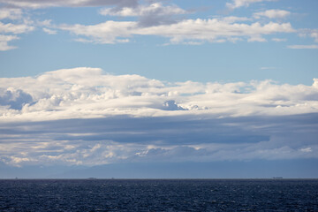 Fototapeta premium Dramatic Cloud Layers Over Open Ocean Horizon Near Tsawwassen, British Columbia, Canada