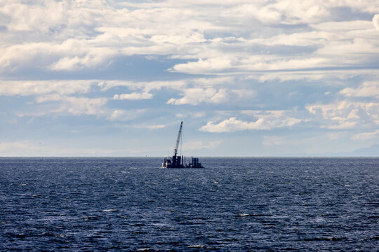 Offshore Construction Barge On Calm Ocean With Layered Clouds Over Tsawwassen British Columbia Canada