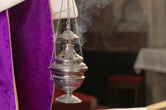 A Catholic priest leads Holy Mass in a historic church in Europe. The priest performs Eucharistic rituals and Incensation.