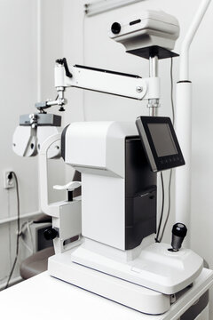 Autorefractor on a medical desk in a modern optometrist's office. Concept eye diagnostics, vision testing, ophthalmic equipment, medical technology, eye care.