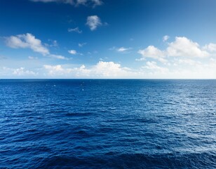 Fototapeta premium a vast horizon of the ocean with a few light clouds