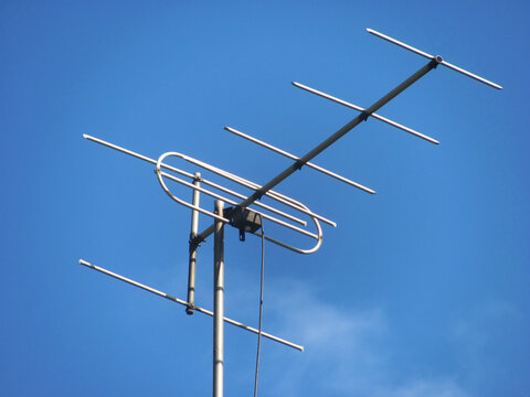 Outdoor television antenna for VHF channels against a clear blue sky