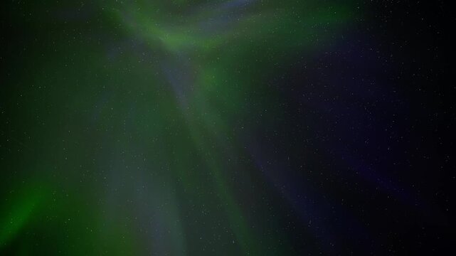 Multicolored Aurora Northern Lights swirl and radiate across a stary sky creating angel wing patterns. Night sky time-lapse.
