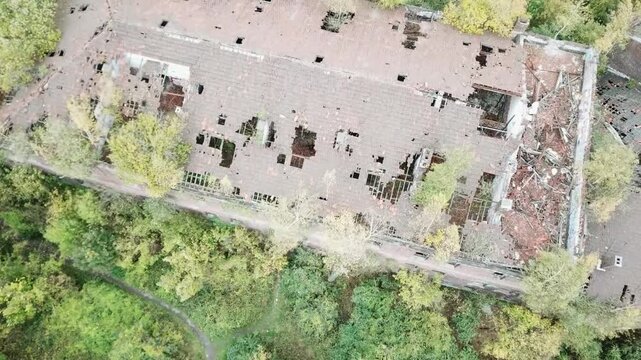 An aerial shot of a large fort in Belgium, empty since 1988, with trees growing through the roof in Li&egrave;ge as nature slowly reclaims the structure