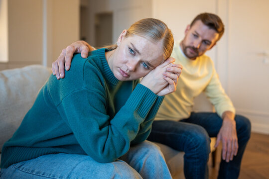 Married couple in toxic relationships, guilty man partner trying to make peace with distressed wife, offended woman turned away from husband showing coldness and offence, manipulative emotions.