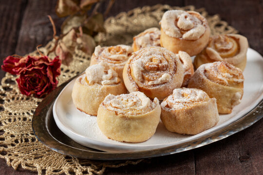 Traditional Moldavian rose-shaped cookies with meringue filling, served on a ceramic plate.