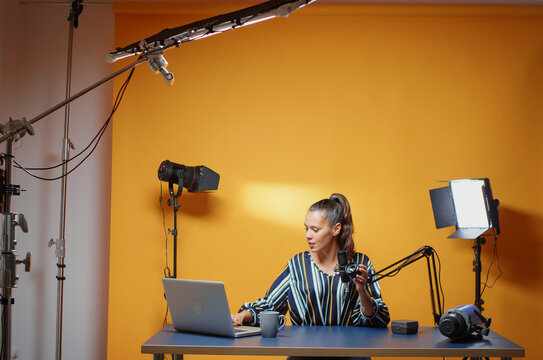 Content creator records professional studio content for subscribers while explaining lighting equipment, modifier use and practical studio production for online video subscribers.