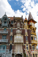Fototapeta premium Houses of Mers-les-Bains, seaside town with 19th-century sea-bathing villas with colorful wooden balconies and white chalk cliffs, tourists destination in France