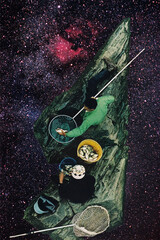 Two fishermen caught a large number of fish. They were perched on a rock floating in the middle of the universe, surrounded by countless galaxies and twinkling stars. © Lerson Pannawit