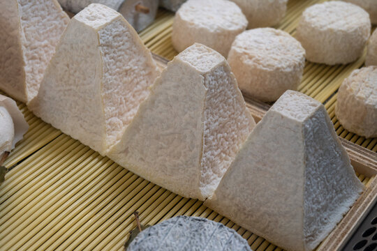 Pouligny-Saint-Pierre AOC goat cheese with its distinctive pyramid shape. Creamy, tangy artisanal French cheese from the Loire Valley with white mold rind, gourmet delicacy, France