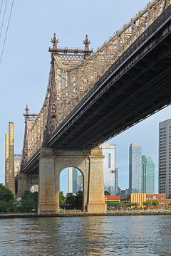 River against background of Queensboro bridge in New York City. Queensboro, officially Ed Koch Queensboro Bridge, cantilever bridge over East River in New York City. Completed in 1909