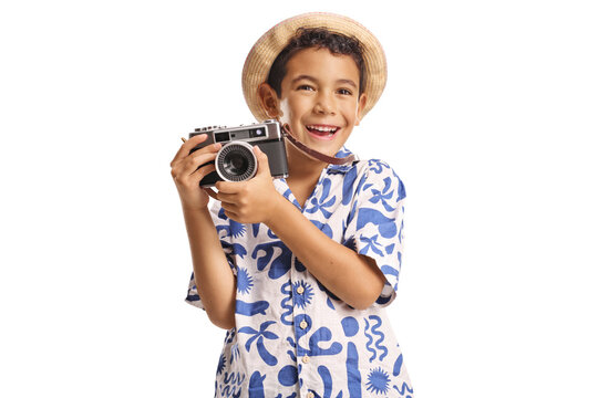 Cheerful kid tourist holding a vintage photo camera