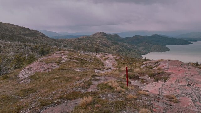 Rising above a rugged Patagonia landscape with trail markers showing the way on the W Trek in Torres del Paine, Chile