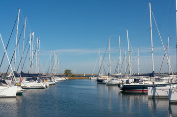 Fototapeta premium Marina, yachts at piers, a ‘palisade’ of masts. Stellendam, (village), Netherlands.