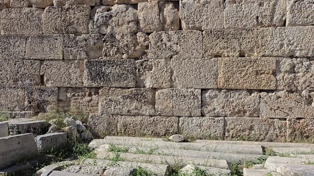 Athens, Greece - 22 June 2026. Close view of the limestone ashlar wall of the Early Christian Tetraconch, Basilica of Megali Panagia, beside Hadrian's Library, with reused masonry and repair work.