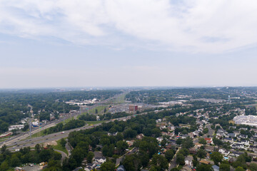 Fototapeta premium Aerial view of suburban landscape with highway traffic