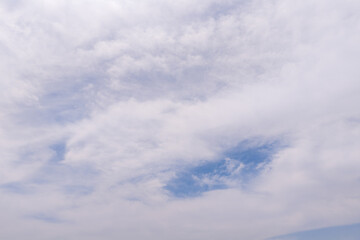 Fototapeta premium Sky with gentle clouds covering blue background